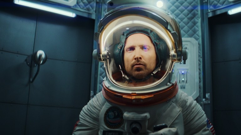 Astronaut Cliff Stanfield (Aaron Paul) stands in a space suit in Black Mirror episode "Beyond the Sea"