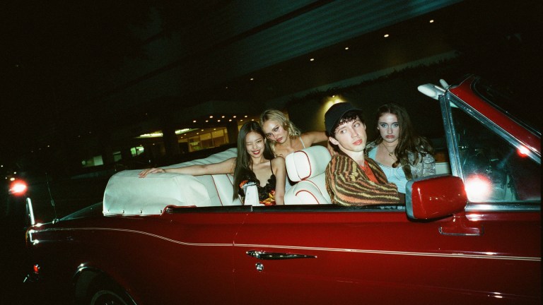Dyanne (Jennie Ruby Jane), Jocelyn (Lily-Rose Depp), Xander (Troye Sivan), and Leia (Rachel Sennott) sit in a red convertible in HBO's The Idol
