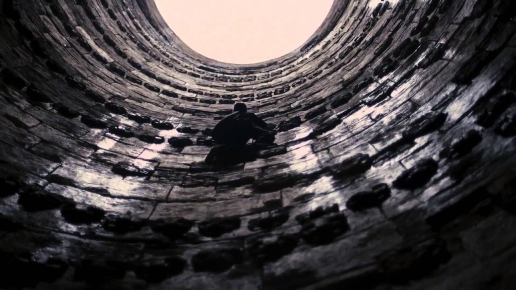 Bruce Climbing out of pit in The Dark Knight Rises