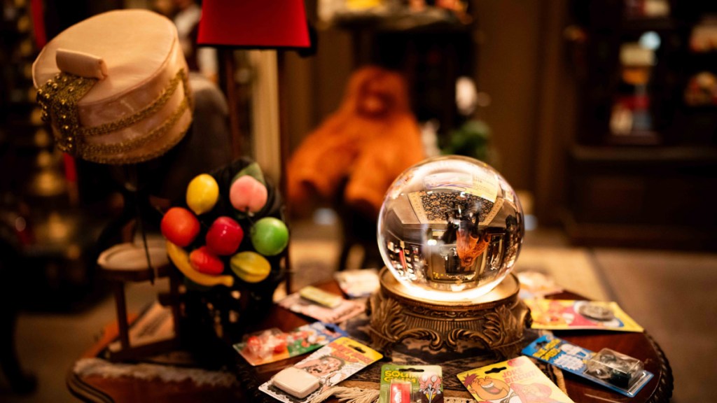 Good Omens season 2 Magic Shop: Librarian Orangutan, Doctor Who fez, Agnes crystal ball. Credit: Prime Video