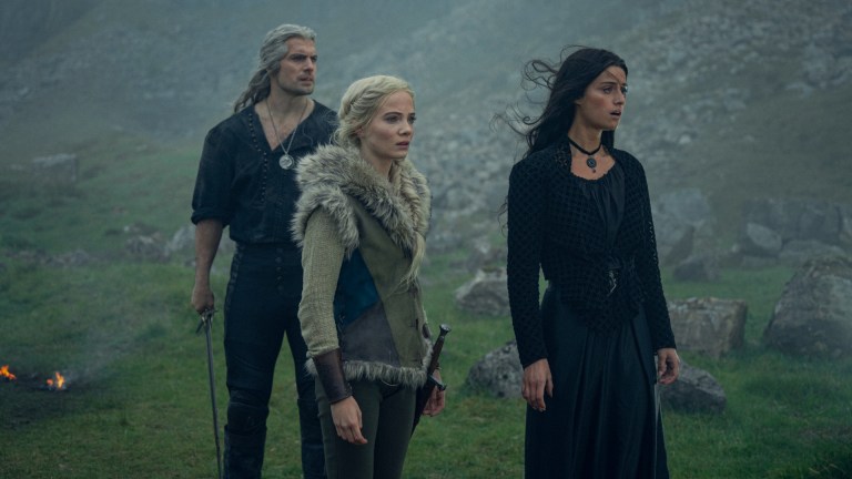 Geralt (Henry Cavill), Ciri (Freya Allan), and Yennefer (Anya Chalotra) stand in the lush countryside outside of Aretuza in The Witcher