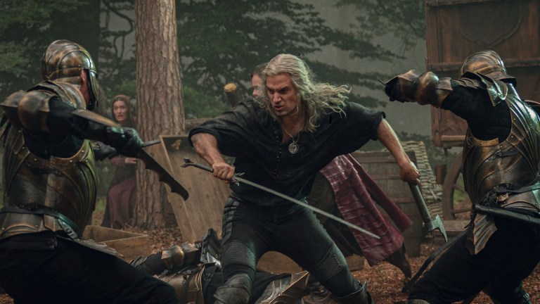 Geralt (Henry Cavill) fights a squad of Nilfgaardian soldiers in The Witcher