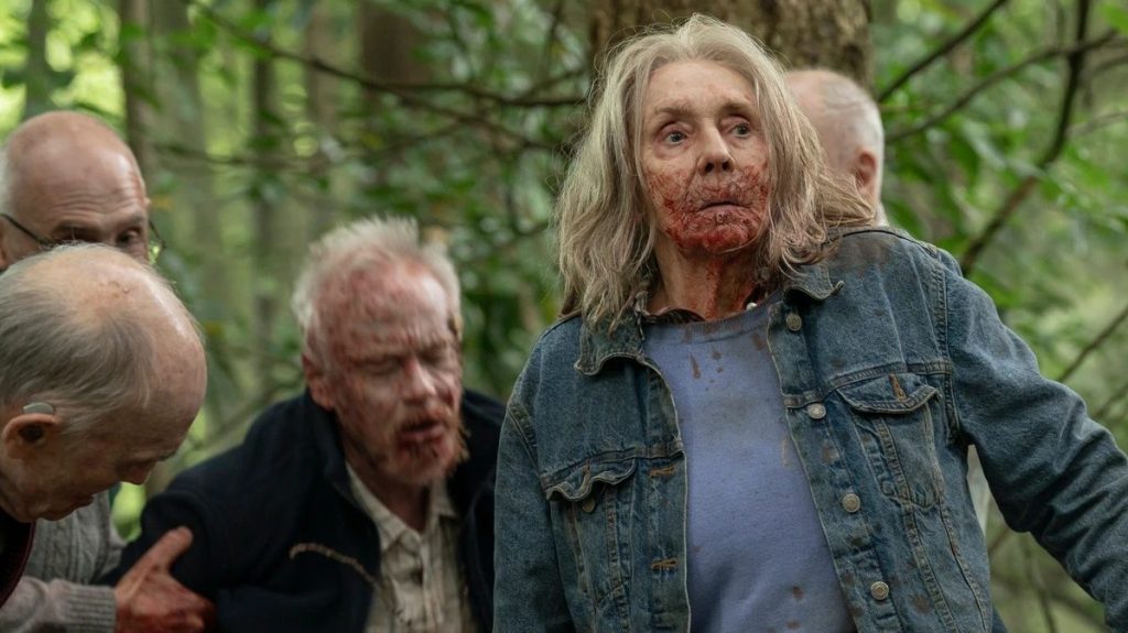 Sue Johnston and co-stars in a forest with blood around their mouths for Generation Z