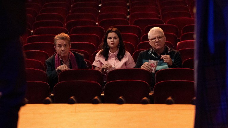 Oliver Putnam (Martin Short), Mabel Mora (Selena Gomez), and Charles-Haden Savage (Steve Martin) sit in the velvety red seats of a Broadway theater