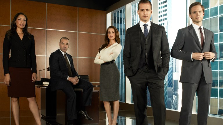 SUITS -- Season 1 -- Pictured: (l-r) Gina Torres as Jessica Pearson, Rick Hoffmann as Louis Litt, Meghan Markle as Rachel Zane, Gabriel Macht as Harvey Specter, Patrick Adams as Mike Ross