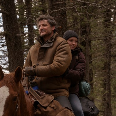 Joel (Pedro Pascal) and Ellie (Bella Ramsey) ride on the back of a horse through the wilderness in HBO's The Last of Us