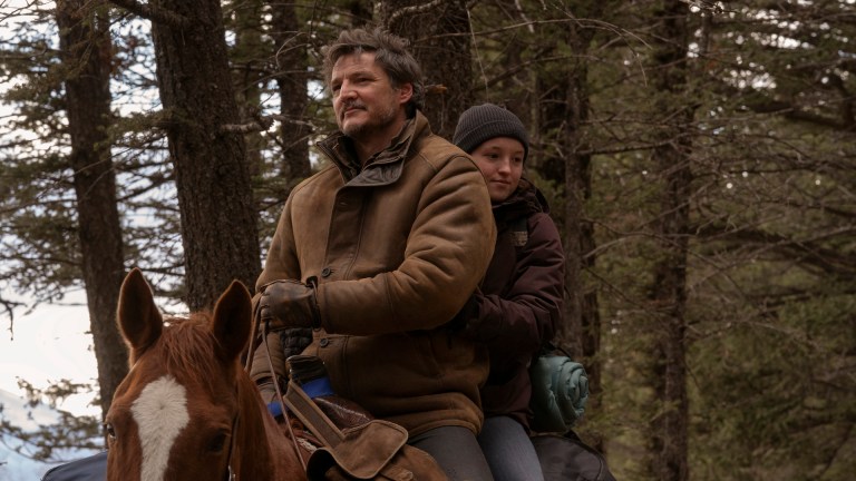 Joel (Pedro Pascal) and Ellie (Bella Ramsey) ride on the back of a horse through the wilderness in HBO's The Last of Us