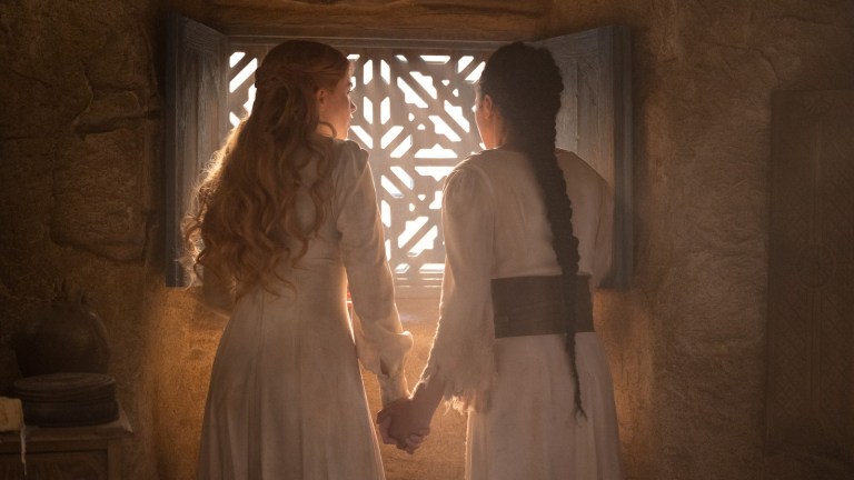 Elayne and Nynaeve hold hands by the window in The Wheel of Time