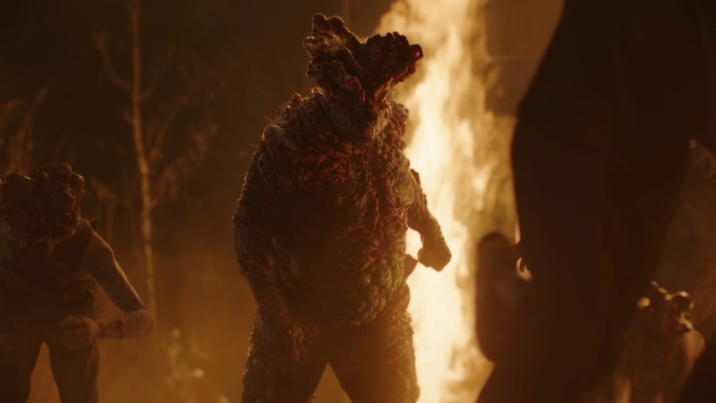 A massive Cordyceps infected creature known as a Bloater stands menacingly with fire glowing in the background
