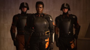 Hunter B-15 (Wunmi Mosaku) leads a pair of Time-Keepers down a TVA hallway
