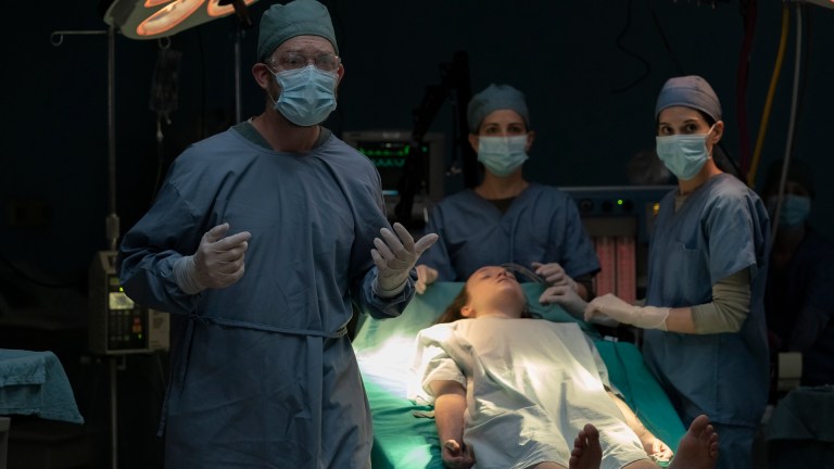 Ellie (Bella Ramsey) lies unconscious on an operating table as doctors and nurses prepare to remove the Cordyceps from her brain