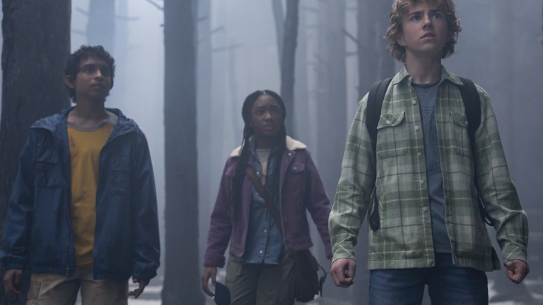 Grover (Aryan Simhadri), Annabeth (Leah Sava Jeffries), and Percy (Walker Scobell) stand in a spooky forest in Percy Jackson and the Olympians