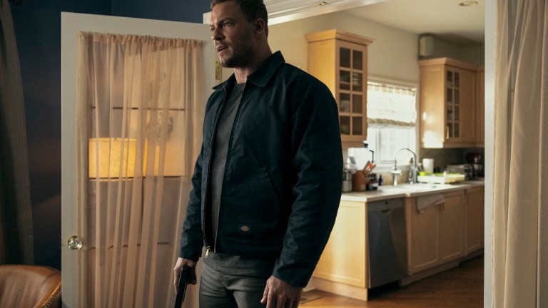 Jack Reacher (Alan Ritchson) stands in a living room, ready to fight in Prime Video's Reacher season 2