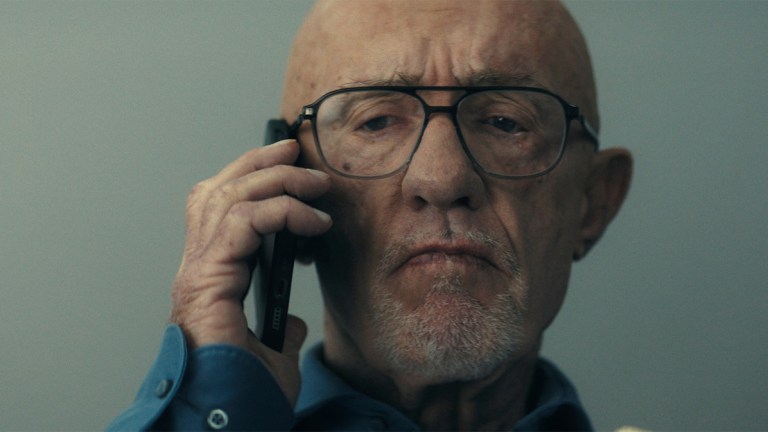 Jonathan Banks in a blue shirt talking on the phone in Apple TV+ Constellation
