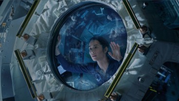Noomi Rapace as Joanna Eriksson looking out of a window on the ISS in Apple TV+ show Constellation