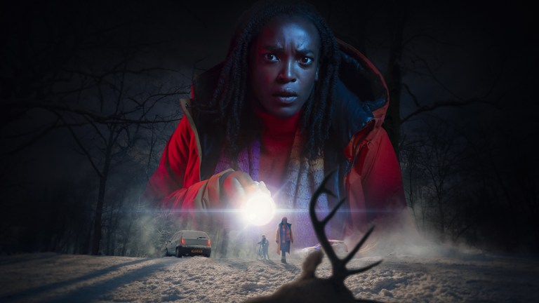 Wunmi Mosaku holding a flashlight on a snowy road for ITV's Passenger