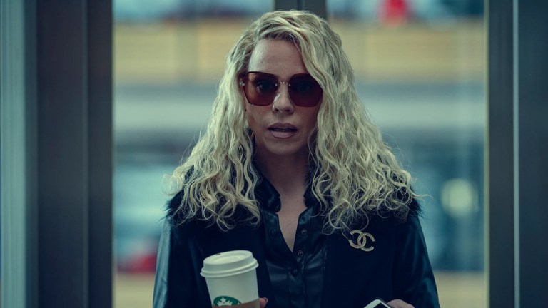 Billie Piper wearing sunglasses and carrying a takeaway drink in Netflix film Scoop