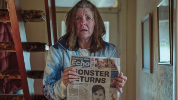 Clare Burt playing Sue Goodheart holding a newspaper up and looking worried in ITV's Passenger