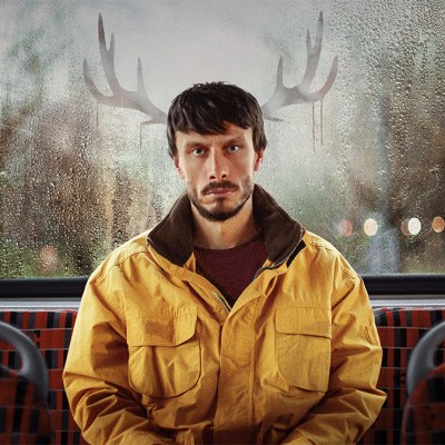 Richard Gadd in a yellow jacket with antlers in the poster for Netflix drama Baby Reindeer