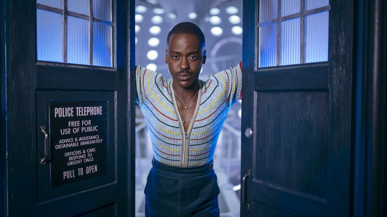 Ncuti Gatwa as The Doctor standing in the TARDIS doors