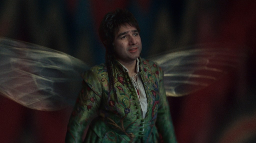 Nick Mohammed in a green suit and wings as supernatural sprite Billy Blind in Renegade Nell