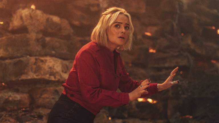 Millie Gibson in a red jacket on a war-torn planet in Doctor Who episode "Boom"