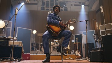 Ncuti Gatwa as The Doctor in 1960s clothing playing a guitar in Doctor Who episode "The Devil's Chord"