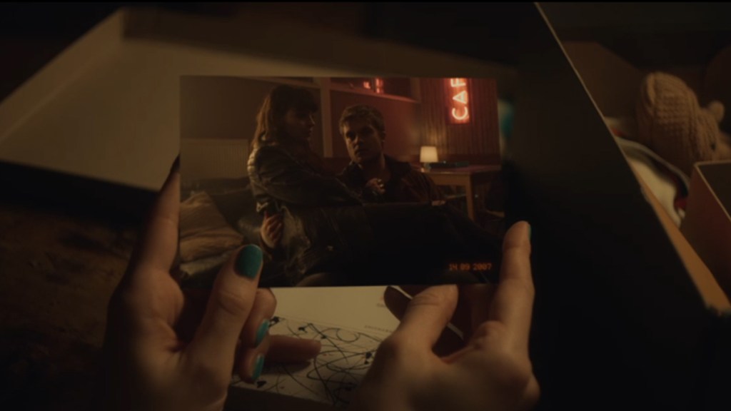 A screengrab of hands holding a photograph of a young girl sitting on an older man&rsquo;s lap in BBC drama The Jetty