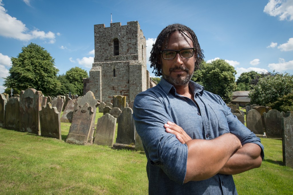 Programme Name: A Black History of Britain - TX: 17/10/2016 - Episode: Ep 1 (No. Ep 1) - Picture Shows: David Olusoga at St Michael’s Church, Burgh-by-Sands. A Roman Fort guarded by African troops once stood on this site. David Olusoga - (C) BBC - Photographer: Des Willie