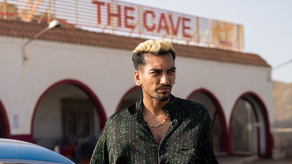 Nabhaan Rizwan standing next to a club called The Cave in Netflix series KAOS