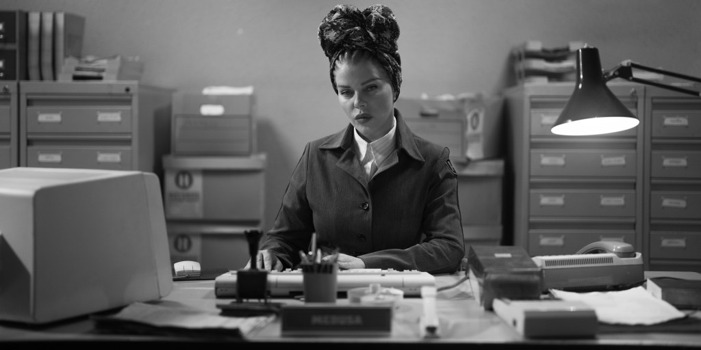Debi Mazar as Medusa in Netflix&rsquo;s KAOS wearing a headscarf, in black and white