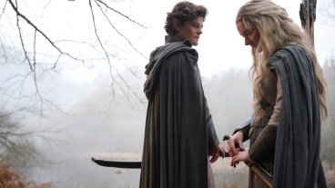 Elrond (Robert Aramayo) and Galadriel (Morfydd Clark) stand in a foggy wood in The Rings of Power season 2