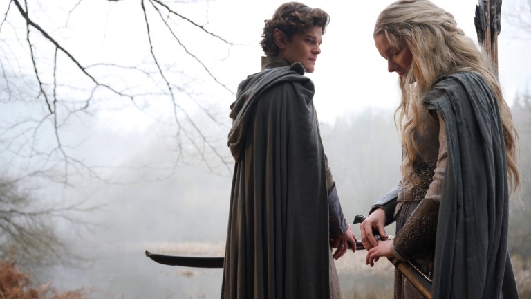 Elrond (Robert Aramayo) and Galadriel (Morfydd Clark) stand in a foggy wood in The Rings of Power season 2
