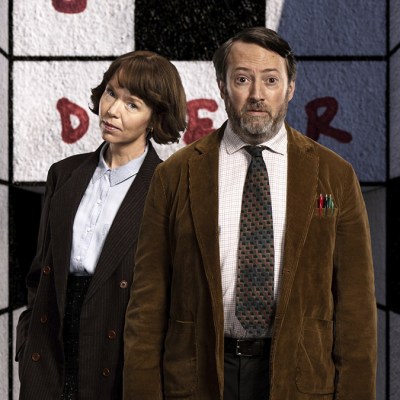 Anna Maxwell Martin and David Mitchell as Lucy and John in Ludwig against a backdrop of a giant crossword grid