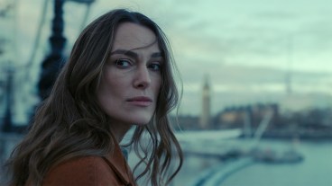 Keira Knightley standing next to the Thames river in Black Doves