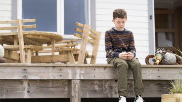 Noah Bett sitting on a veranda in Shetland series 9