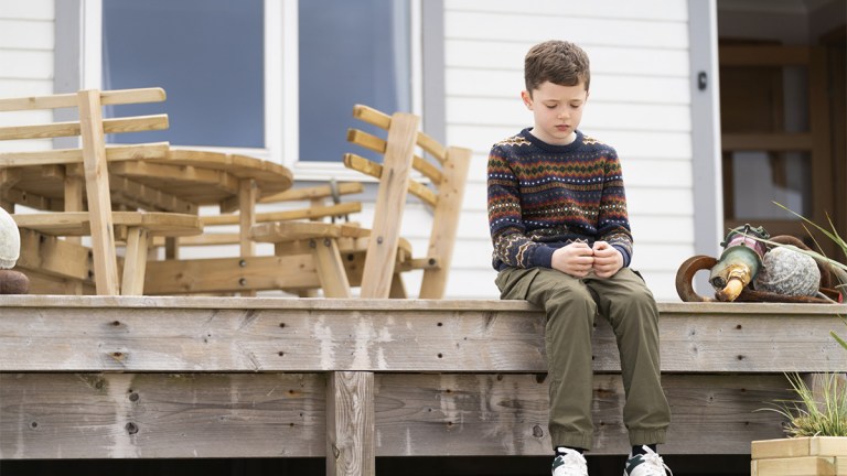 Noah Bett sitting on a veranda in Shetland series 9