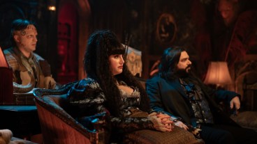 “WHAT WE DO IN THE SHADOWS” -- “The Promotion” -- Season 6, Episode 10 (Airs Dec 9) — Pictured (L-R): Andy Assaf as Monster, Natasia Demetriou as Nadja, Matt Berry as Laszlo.