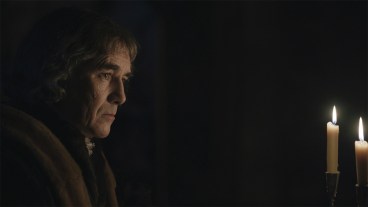 Mark Rylance in the darkness with some candles in Wolf Hall: The Mirror and the Light