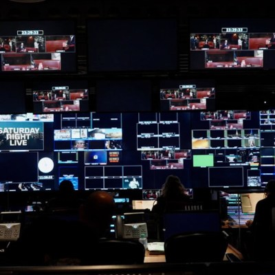 An image of the Saturday Night Live control room with many lit-up monitors.