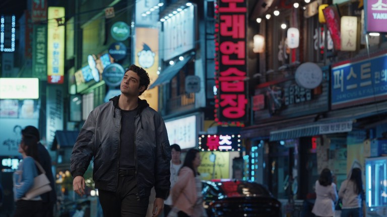 Noah Centineo as Owen Hendricks walking through the streets of South Korea in Episode 201 of The Recruit