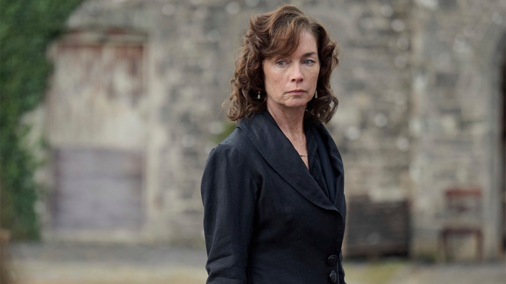 A brunette woman in a black coat in BBC One&rsquo;s Dope Girls