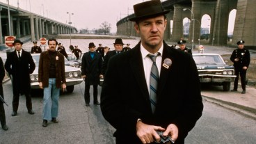Policeman Gene Hackman is shown in this movie still walking toward the camera. He is holding a gun in his hands with policemen and police vehicles in the background. It was in this movie The French Connection that Gene Hackman won "Best Actor." The movie itself won "Best Picture."