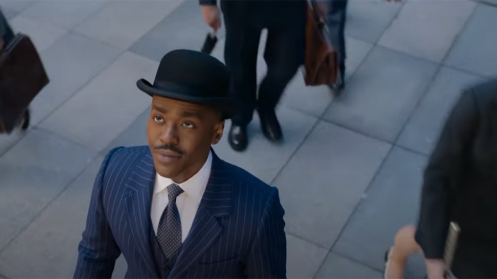Ncuti Gatwa wearing a bowler hat and blue pinstripe suit in Doctor Who