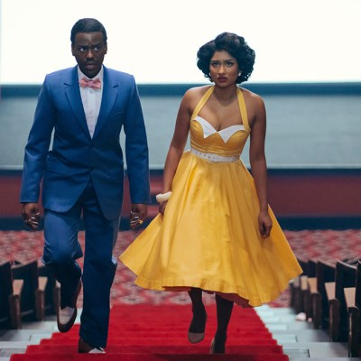 Ncuti Gatwa and Varada Sethu in 1950s clothing walking up the aisle of a cinema in Doctor Who episode Lux