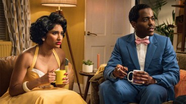 Varada Sethu and Ncuti Gatwa wearing 1950s clothing sitting holding coffee mugs