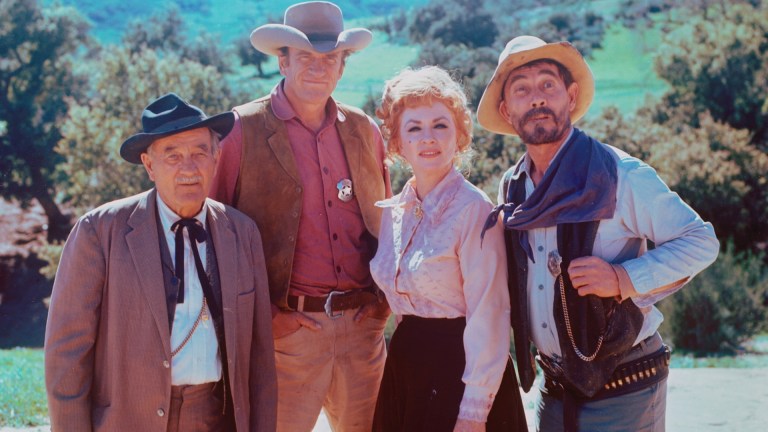 GUNSMOKE. Cast members (from left) Milburn Stone (as Dr. Galen Adams), James Arness (as U.S. Marshal Matt Dillon), Amanda Blake (as Kitty Russell) and Ken Curtis (as U.S. Deputy Marshal Festus Haggen). Image dated June 1970. Copyright CBS Broadcasting Inc. All Rights Reserved.