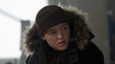 Ellie (Bella Ramsey) looks at something in The Last of Us Part II