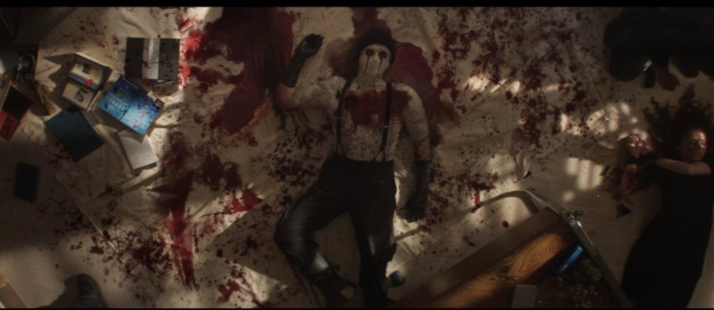 Daredevil: Born Again screenshot of Muse's lifeless body body sprawled out on a floor canvas.