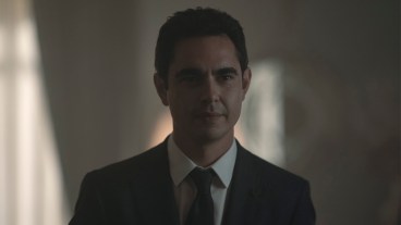Max Minghella wearing a black suit and tie and white shirt in The Handmaid's Tale season 6